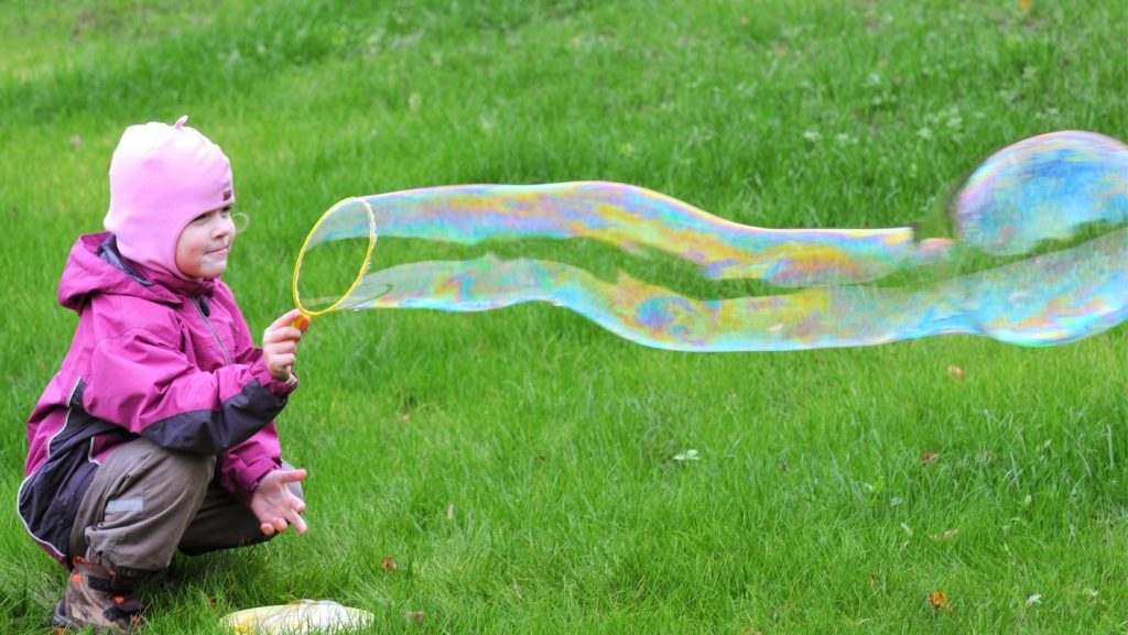 girl blowing giant bubble