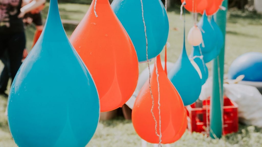 water balloons hanging by strings as targets
