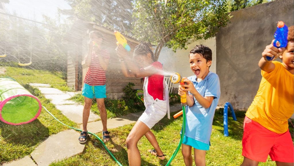 kids playing with hoses and squirt guns